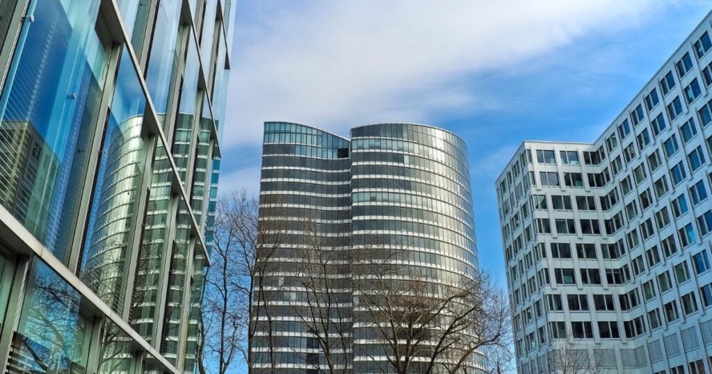 Modern office skyscrapers against a clear blue sky.