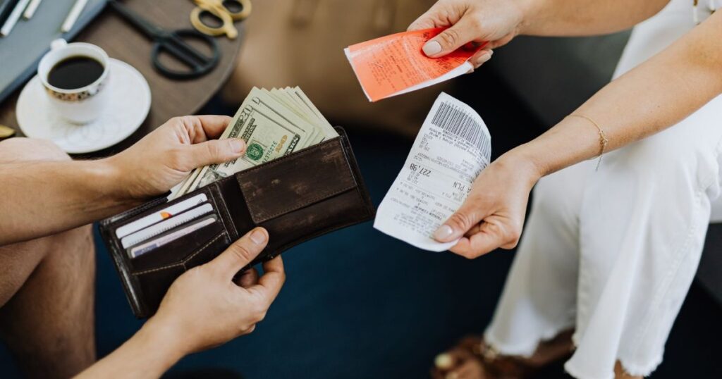 Cash and receipts on a table during a payment.