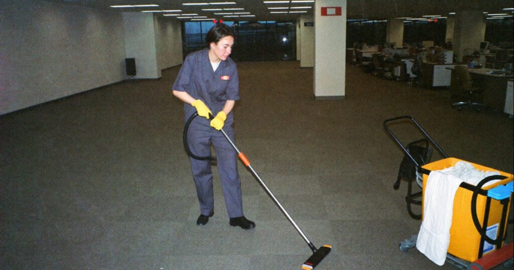 Commercial cleaner vacuuming an office after hours